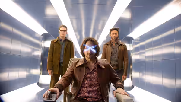 Kitty Pryde (Elliot Page) sits in a corridor as Logan and Charles Xavier stand behind her