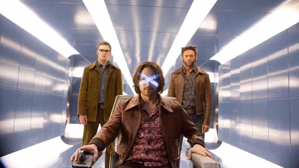 Kitty Pryde (Elliot Page) sits in a corridor as Logan and Charles Xavier stand behind her