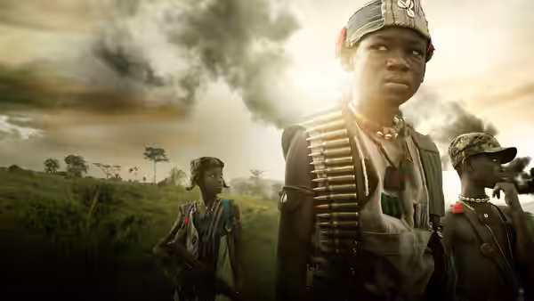 Agu (Abraham Attah) stands armed with fellow child soldiers beneath drifting smoke