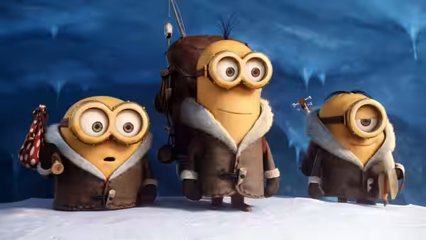 Three Minions in fur-lined coats stand on a snowy landscape with climbing gear