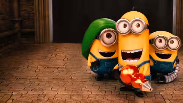 Three Minions grin in a stone corridor as one holds a glowing device