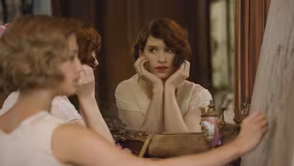 Lili (Eddie Redmayne) studies her reflection at a dressing table
