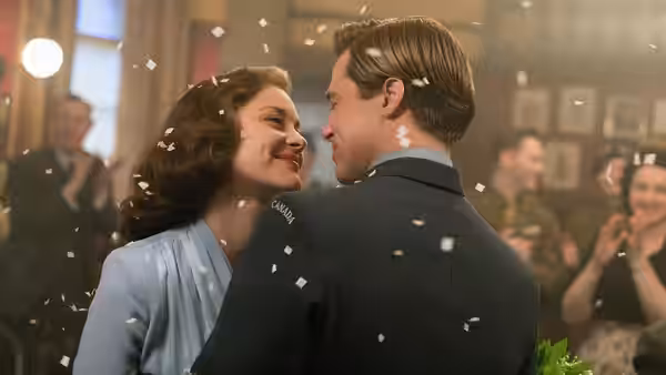 Max Vatan (Brad Pitt) and Marianne Beauséjour (Marion Cotillard) embrace as confetti falls around them