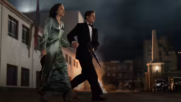 Marianne Beauséjour (Marion Cotillard) and Max Vatan (Brad Pitt) walk armed through a smoky street at night