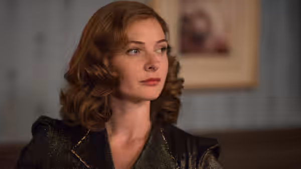 Kathleen Weatherley (Rebecca Ferguson) sits indoors, looking off to the side