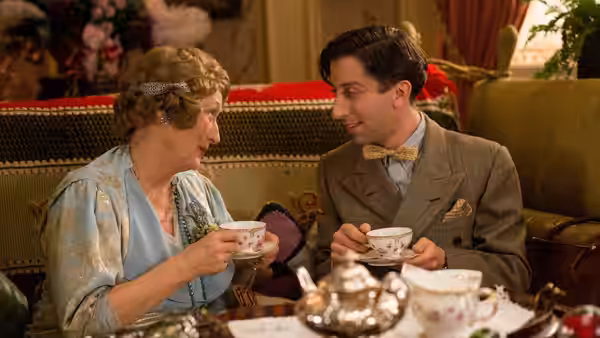 Florence Foster Jenkins (Meryl Streep) and Cosmé McMoon (Simon Helberg) share tea on a sofa