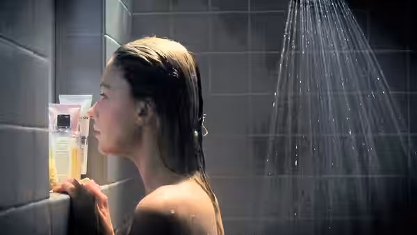 Megan Hipwell (Haley Bennett) stands beneath a shower, reaching toward toiletries