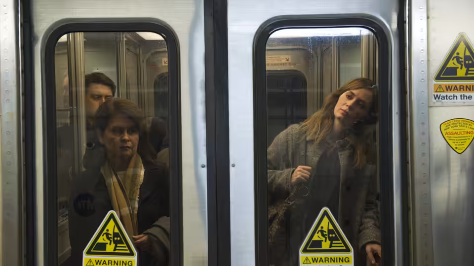 Rachel Watson (Emily Blunt) stands inside a train beside its doors