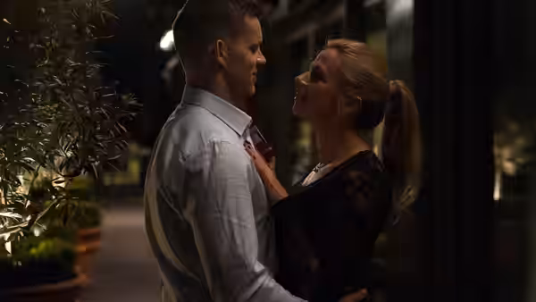 Jason embraces Lyndsey (Lisa McGrillis) outdoors as she touches his shirt