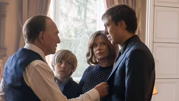 Jean Paul Getty (Christopher Plummer) adjusts John Paul Getty II's suit as Gail and a boy watch