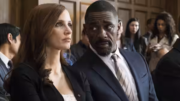 Molly Bloom (Jessica Chastain) and Charlie Jaffey (Idris Elba) sit together in a courtroom