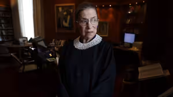 Ruth Bader Ginsburg (Ruth Bader Ginsburg) stands in her office wearing a judicial robe