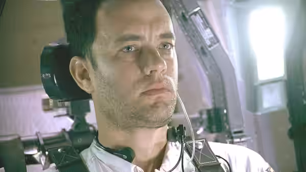 Jim Lovell (Tom Hanks) wearing a headset in the spacecraft