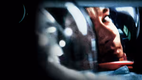 Astronaut in helmet looking out the spacecraft window