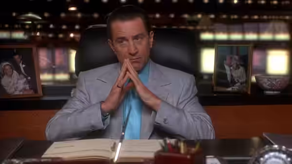 Sam 'Ace' Rothstein (Robert De Niro) seated at an office desk with hands clasped