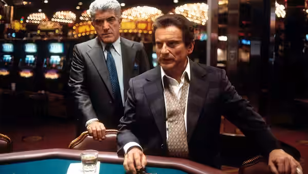 Sam 'Ace' Rothstein (Robert De Niro) leaning on a gaming table in a casino