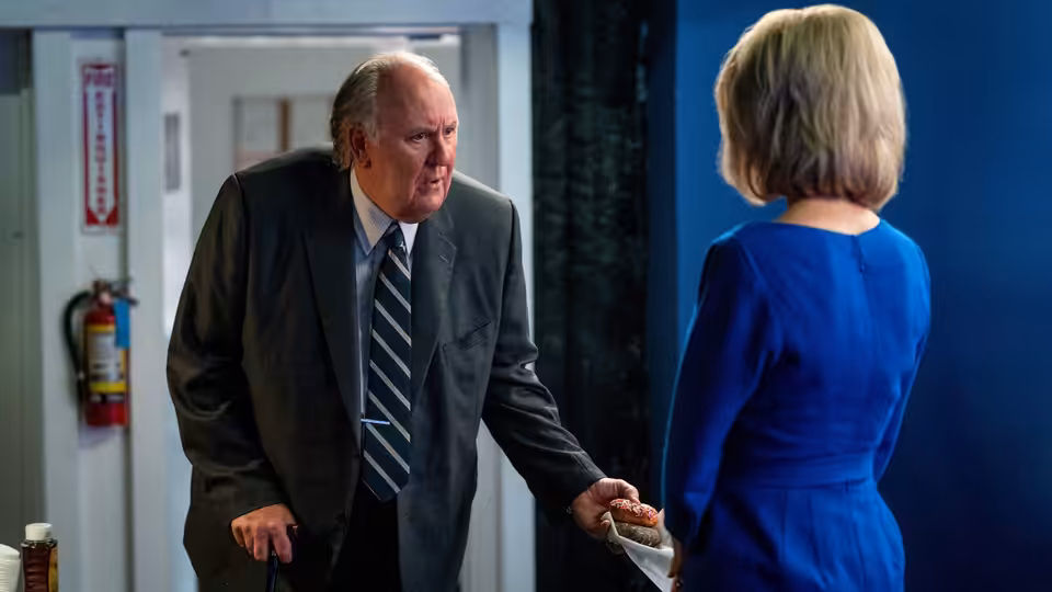 Roger Ailes (John Lithgow) speaks with Megyn Kelly (Charlize Theron) in a doorway