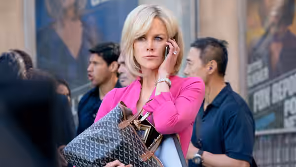 Gretchen Carlson (Nicole Kidman) talks on her phone on a busy sidewalk