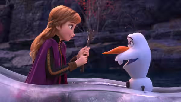 Anna (Kristen Bell) offers Olaf (Josh Gad) a twig beside a rocky stream
