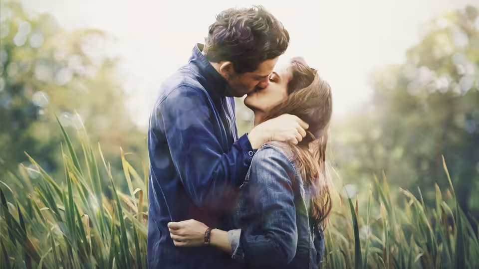 Jake (Josh O'Connor) kisses Elena (Laia Costa) among tall grass