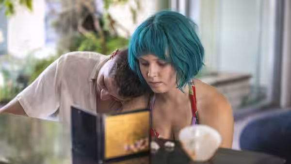 Milla (Eliza Scanlen) and Moses (Toby Wallace) lean together over a book at a table