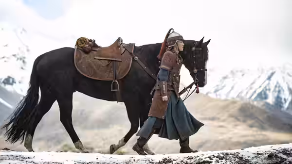 Hua Mulan (Liu Yifei) leads her horse across a snowy mountain path