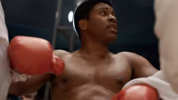 Cassius Clay (Eli Goree) stands between boxing handlers in the ring