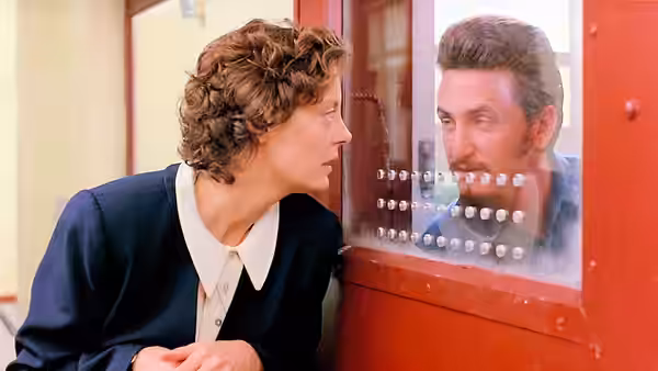 Sister Helen Prejean (Susan Sarandon) speaking to Matthew Poncelet (Sean Penn) at a red door