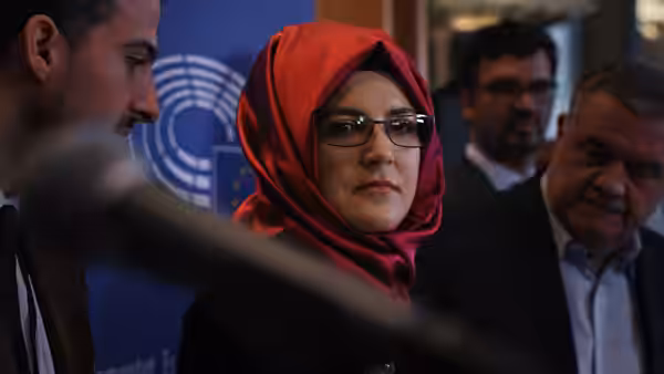 Hatice Cengiz stands among attendees beneath a United Nations emblem