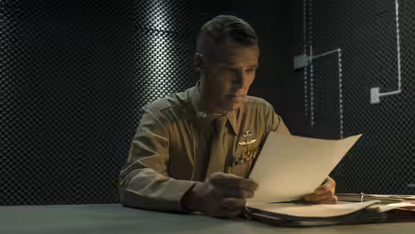 Lt. Stuart Couch (Benedict Cumberbatch) reads a document at a table in a secure room