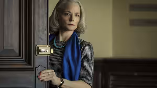 Nancy Hollander (Jodie Foster) pauses in a doorway, holding the door handle