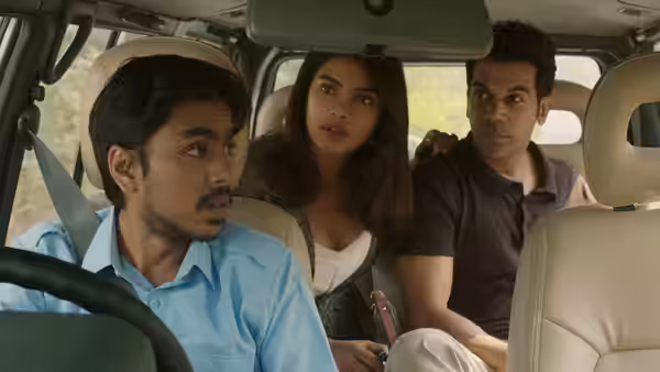 Balram (Adarsh Gourav) drives while Pinky Madam (Priyanka Chopra Jonas) and Ashok (Rajkummar Rao) sit behind him