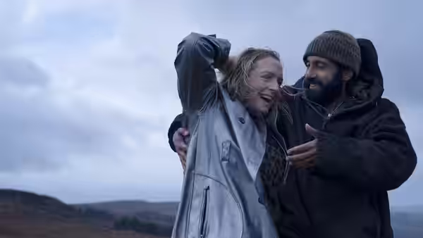 Ali (Adeel Akhtar) embraces Ava (Claire Rushbrook) outdoors as she laughs in the wind