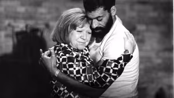 Emmi Kurowski (Brigitte Mira) and Ali (El Hedi ben Salem) embrace in a dim room