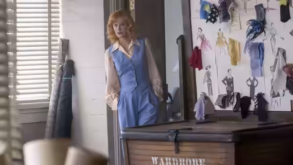 Lucille Ball (Nicole Kidman) stands beside costume sketches in a wardrobe room