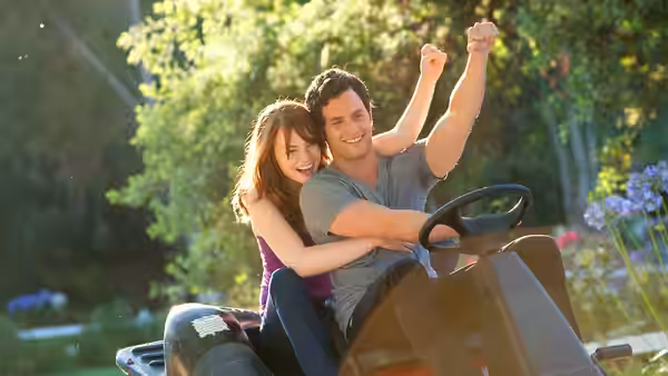 Olive (Emma Stone) hugs Woodchuck Todd (Penn Badgley) as they ride an amusement park attraction