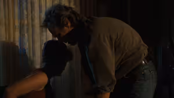 Robert Kincaid (Clint Eastwood) leans toward Francesca Johnson (Meryl Streep) in a dark room