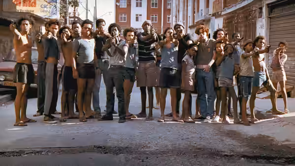 Large group of young people aiming guns on a street