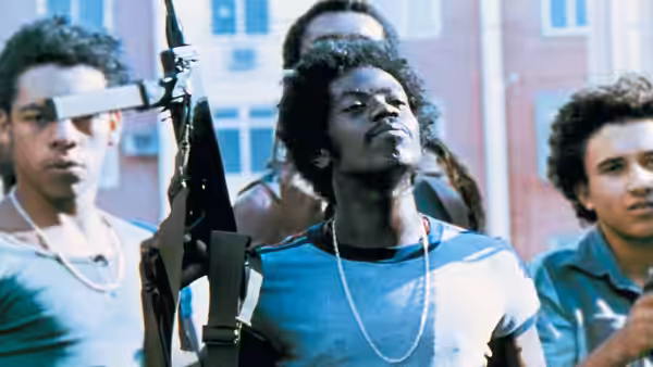 Young men standing together with one holding a rifle