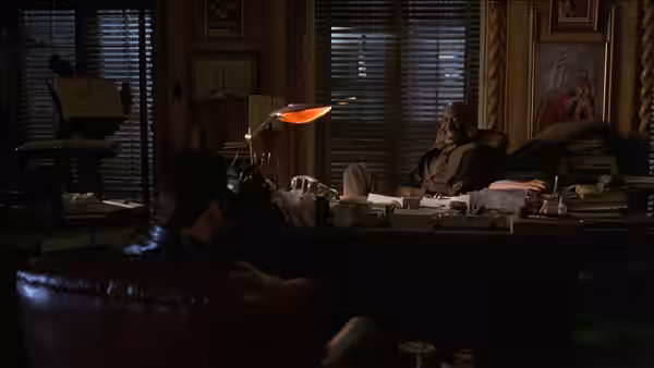 Chili Palmer (John Travolta) faces Bo Catlett (Delroy Lindo) across a desk in an office