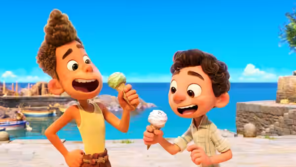 Alberto and Luca compare ice cream cones beside the harbor