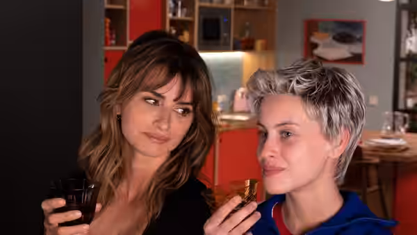 Janis (Penélope Cruz) and Ana (Milena Smit) raise drinks together in a kitchen