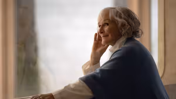 Dr. Eve Scott (Glenn Close) rests her hand against her face beside a window