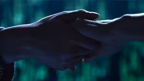 Two hands clasp in a handshake against a blurred green-lit background