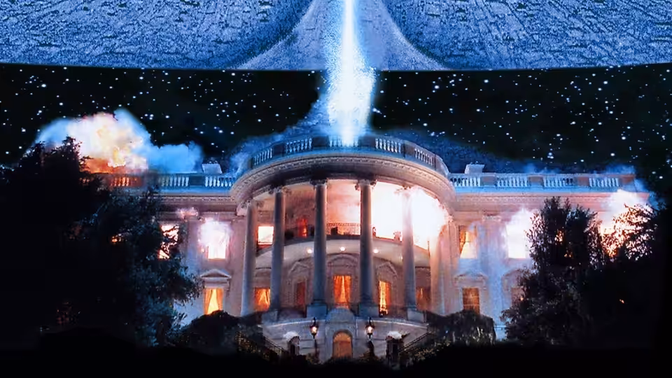 A massive alien spacecraft firing a beam at the White House