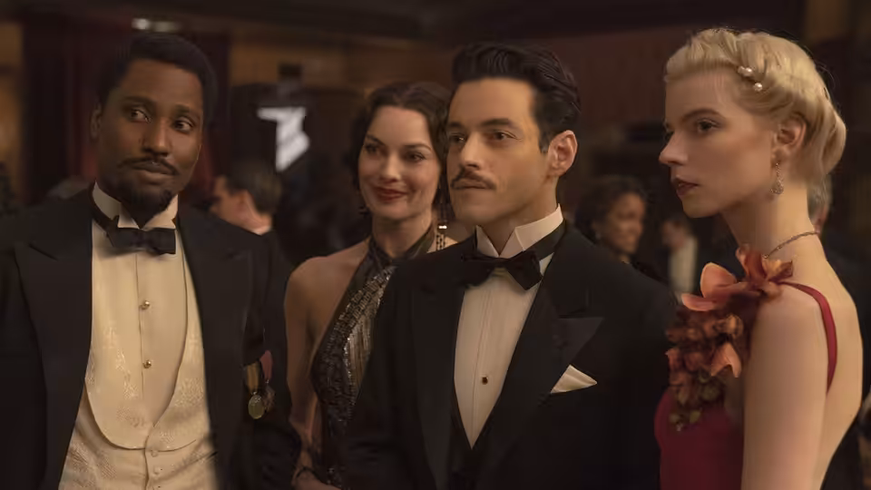 Harold Woodman (John David Washington), Burt Berendsen (Christian Bale), and Valerie Voze (Margot Robbie) mingle at a formal gathering