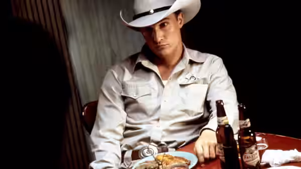 Buddy Deeds (Matthew McConaughey) seated at a table with beer bottles