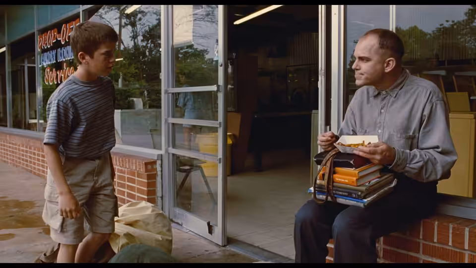 Karl Childers (Billy Bob Thornton) talks with Frank Wheatley outside a repair shop