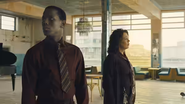 Stephen (Micheal Ward) and Hilary (Olivia Colman) stand apart in the cinema lobby