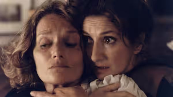 A woman holds Alicia (Norma Aleandro) close as they look anxiously ahead